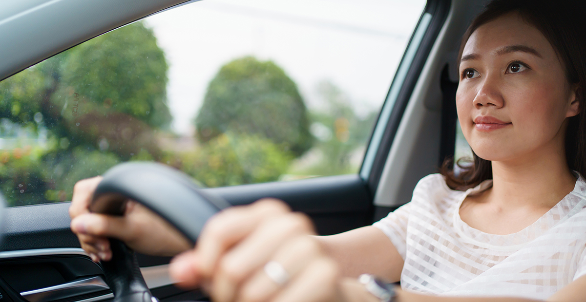 Young woman driving calmly with concentration - Staying alert