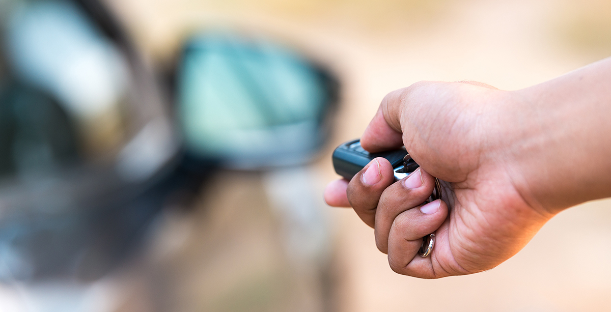 Close up of hand holding car keys - using your car correctly