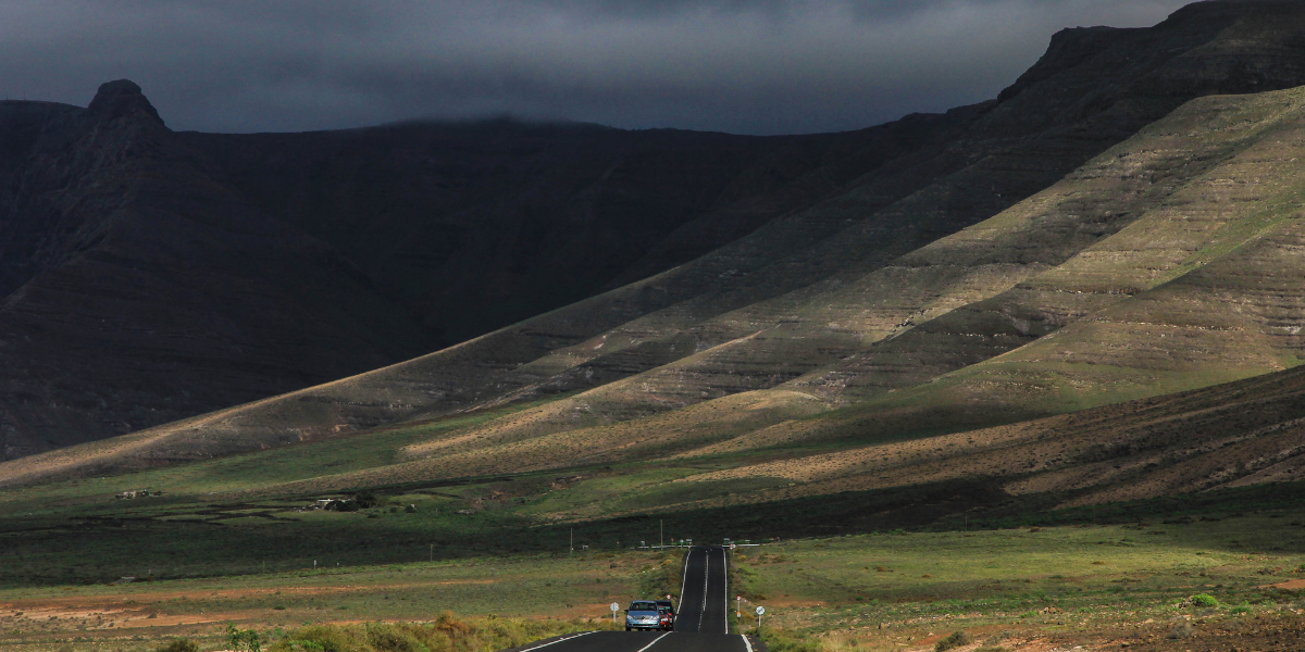 Dark storm clouds looming over rural road